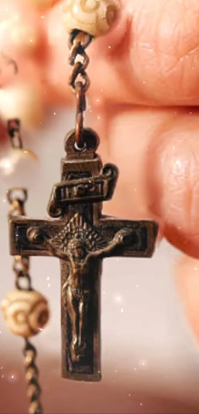 Close-up of a rosary with wooden beads and a cross in hand.