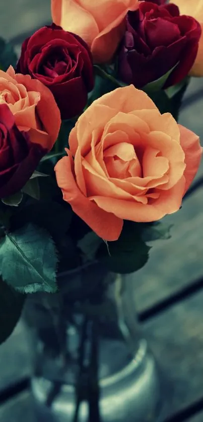 Elegant bouquet of red and peach roses in vase.