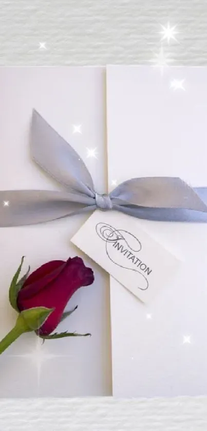 White invitation card with gray ribbon and red rose.