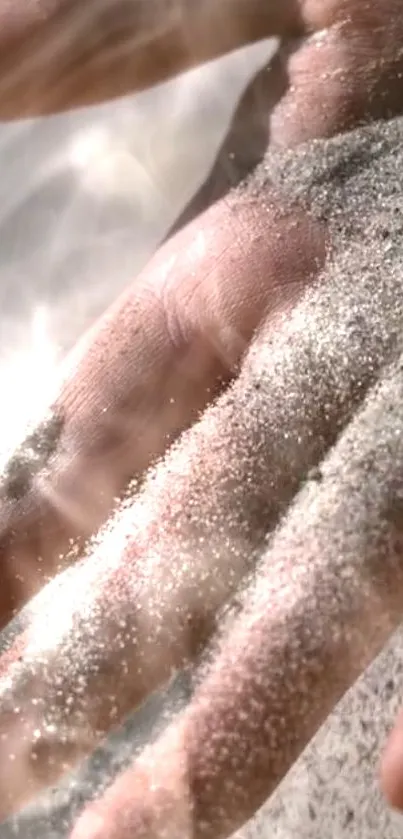 A hand covered in sand with light reflections.