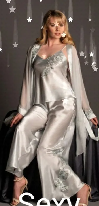 Model in elegant satin attire with gray background.