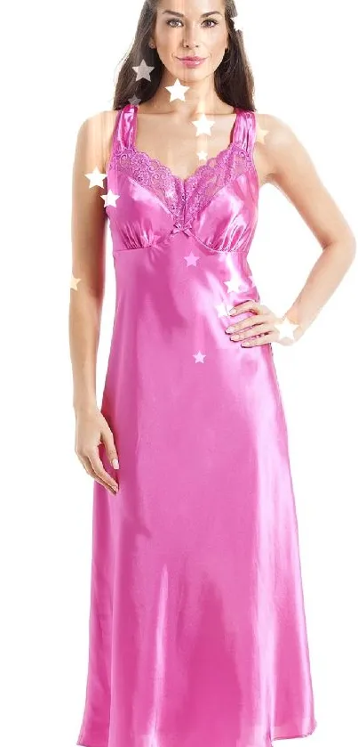 Woman in pink satin nightdress showcasing elegant style.