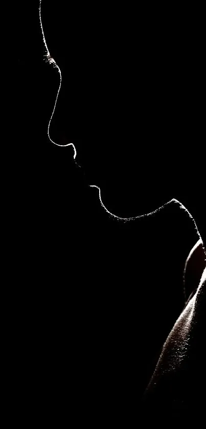 Silhouette of a face against a black background, creating an elegant mobile wallpaper.