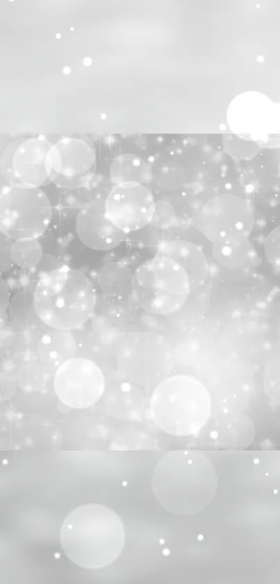 Silver bokeh mobile wallpaper with elegant shimmering circles.