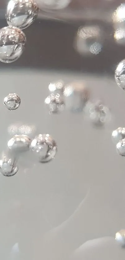 Mobile wallpaper with silver bubbles on a light background.