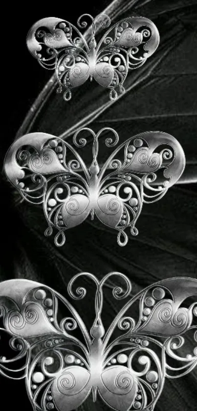 Intricate silver butterfly design on black background.