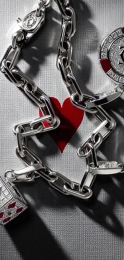 Silver chain with playing cards motif and red heart design.