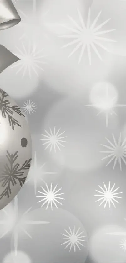 Silver Christmas bauble with snowflakes on a festive background.