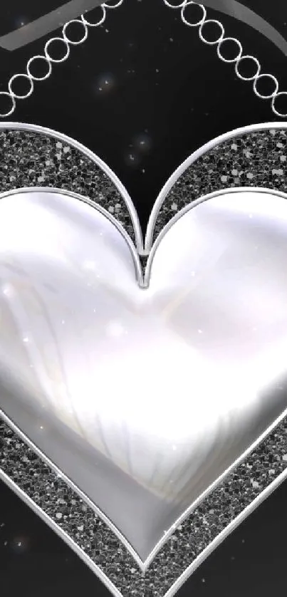 Elegant silver heart with black sparkling border on a black background.