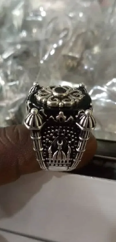 Close-up of an elegant silver ring with intricate design details.