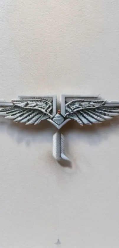 Silver winged emblem on beige background wallpaper.