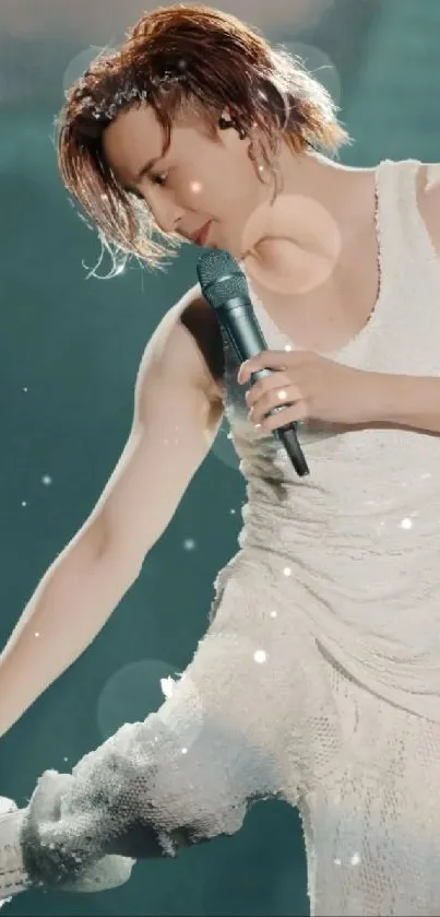 Charismatic singer performing on stage in white outfit.