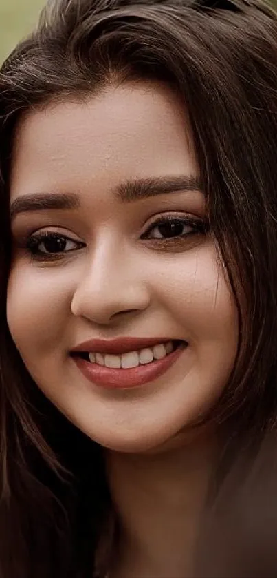 Portrait of a smiling woman with brown hair, exuding elegance and warmth.