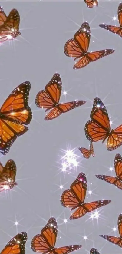 Sparkling orange butterflies on gray mobile wallpaper.