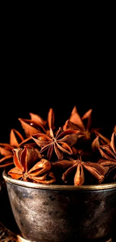 A dark brown coffee cup filled with star anise spices.