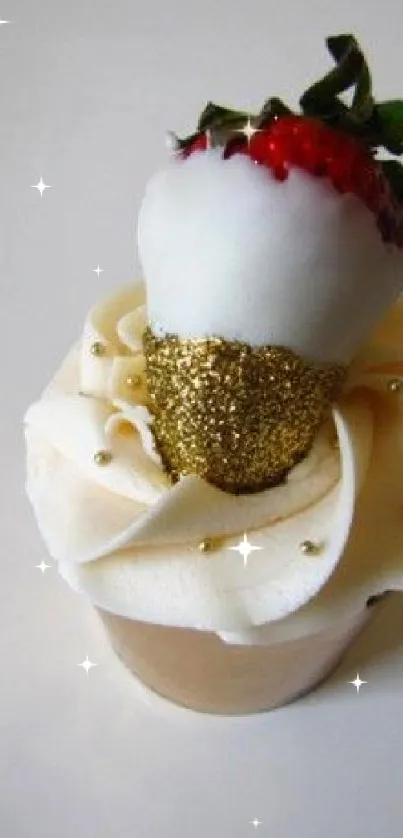 Cupcake topped with a white chocolate-coated strawberry and gold details.