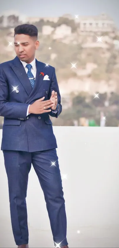 Man in dark blue suit stands outdoors on a bright day.