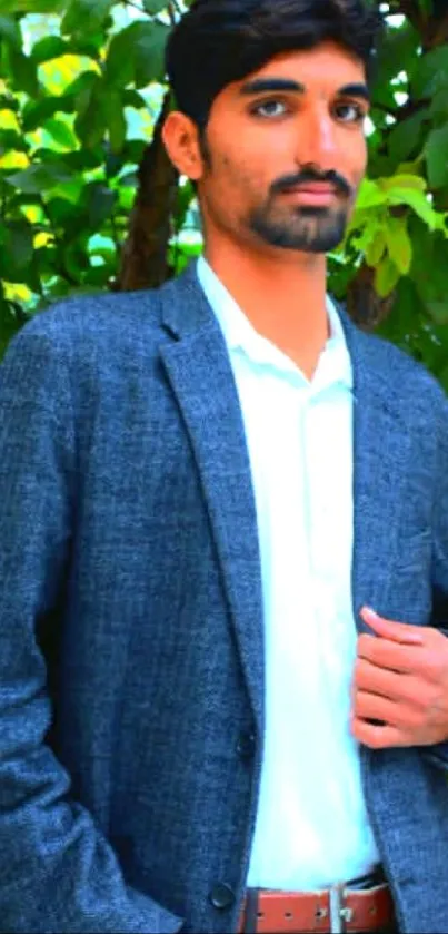 Stylish man in a suit with green leafy background.