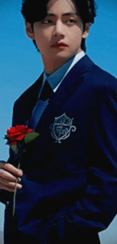 Person in a blue suit holding a red rose with a sky background.