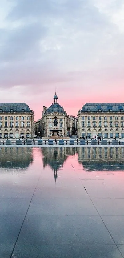 Elegant sunset reflecting on historic architecture and calm water surface.