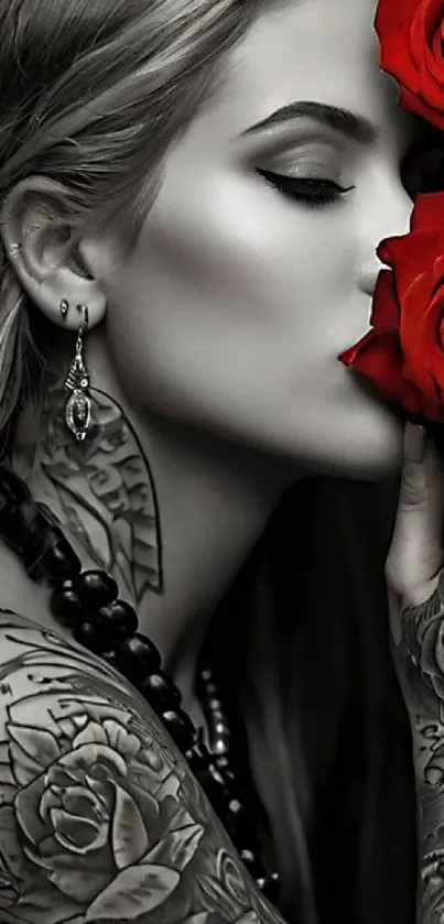 Stylish woman with tattoos holding red roses, creating an elegant and artistic image.