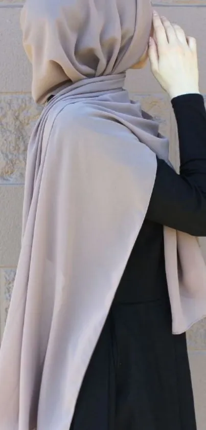 Elegant taupe hijab on woman with black dress.