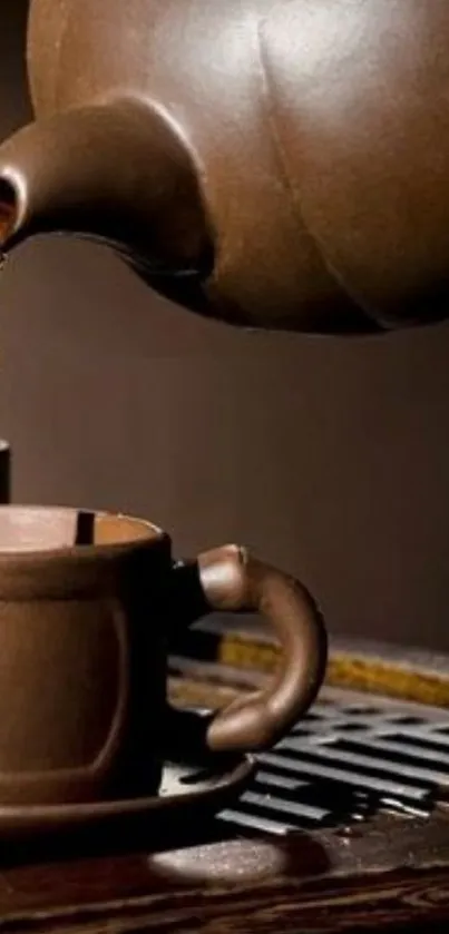 Brown ceramic teapot pouring tea into a matching cup on a rustic saucer.