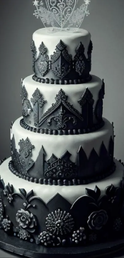 Black and white tiered cake with lace and floral patterns.