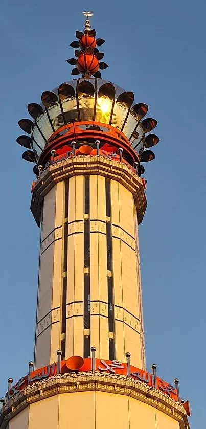 A majestic tower glowing golden against a blue sky, ideal for mobile wallpaper.