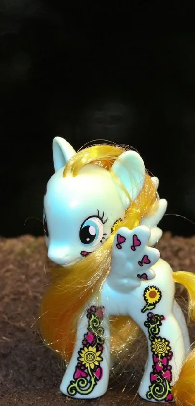 Toy horse with golden mane on earthy background.