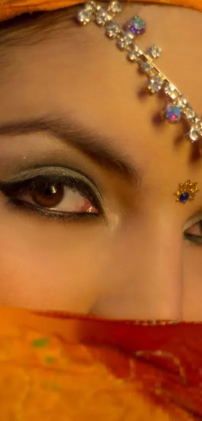 Close-up of eyes with orange and jeweled adornments.