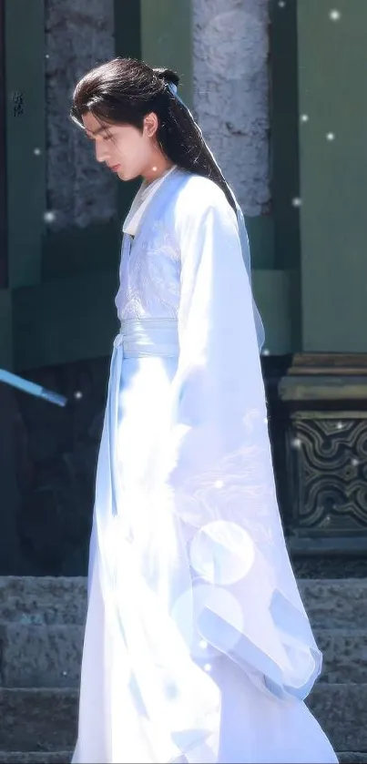 Person in elegant traditional white attire standing outdoors.