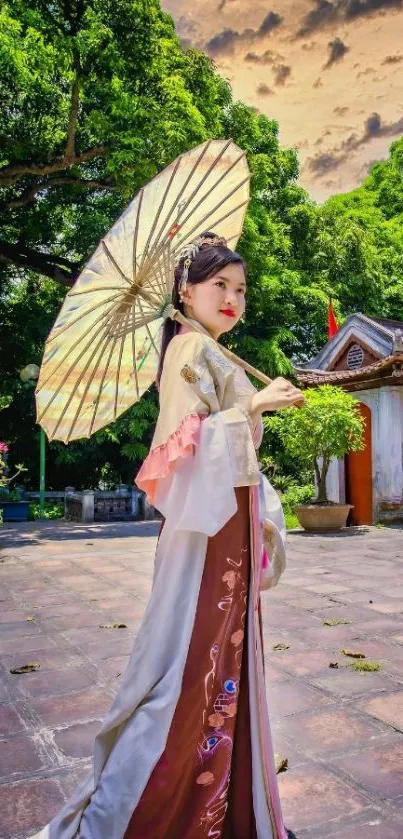 Woman in traditional dress with ornate umbrella in an elegant outdoor scene.