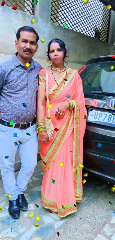 Couple in traditional attire by car.