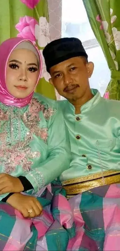 Couple in elegant traditional attire with floral background.