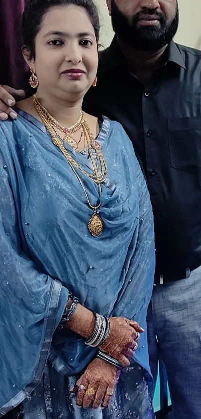 Elegant traditional attire with jewelry in a posed portrait.