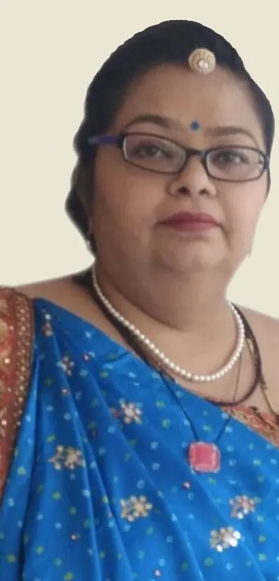 Woman in a blue sari with traditional jewelry, elegant look