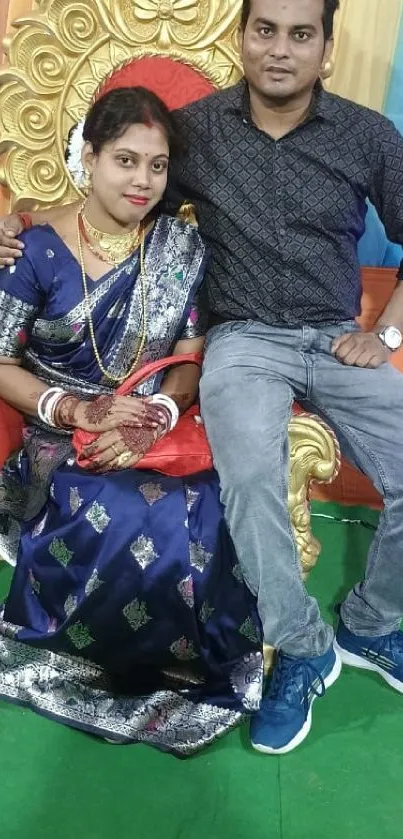 Couple in traditional attire with a colorful background.