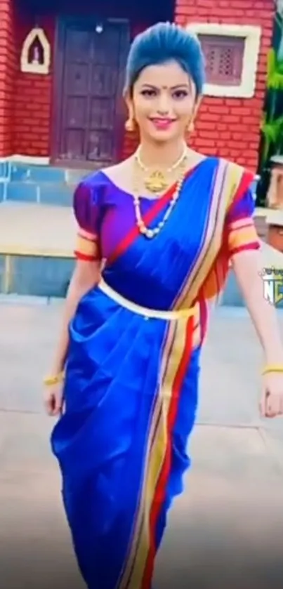 Woman in traditional blue saree with colorful accents.