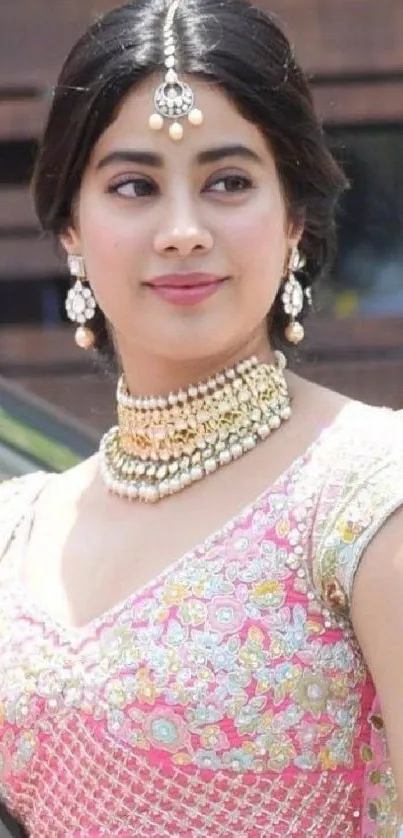 Beautiful woman in embroidered pink traditional attire with jewelry.