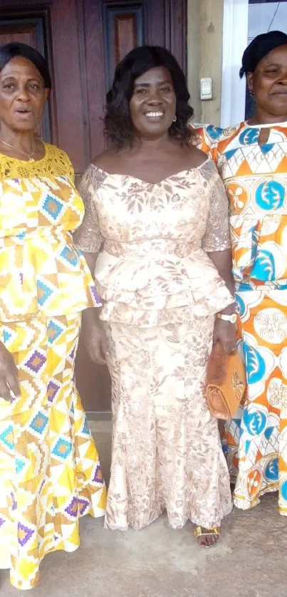 Three women in elegant traditional attire, showcasing vibrant patterns.