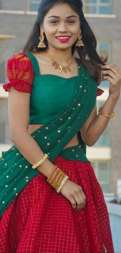 Woman in traditional attire with colorful saree in a vibrant setting.