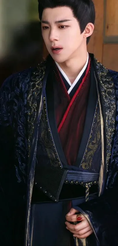 Young man in elegant traditional attire against a wooden backdrop.