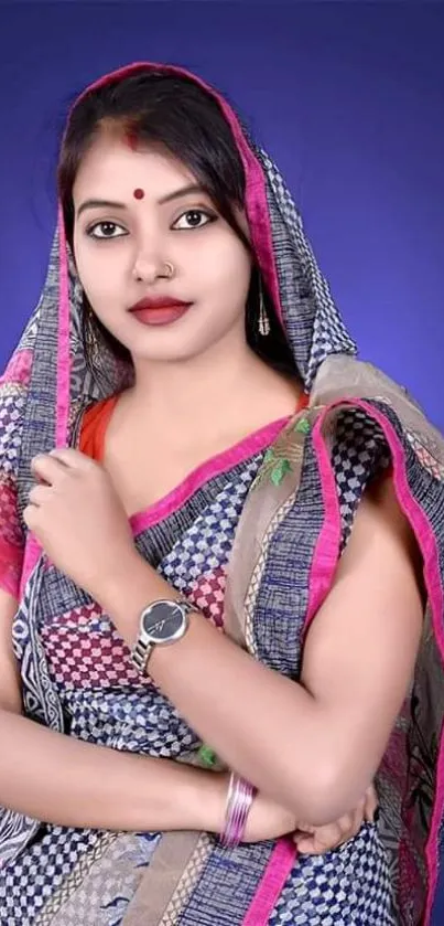 Woman in traditional attire with a royal blue background.