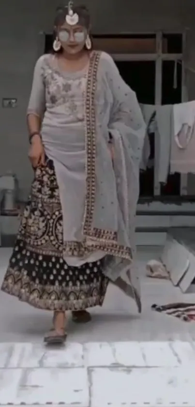 Woman in elegant traditional attire with intricate patterns.