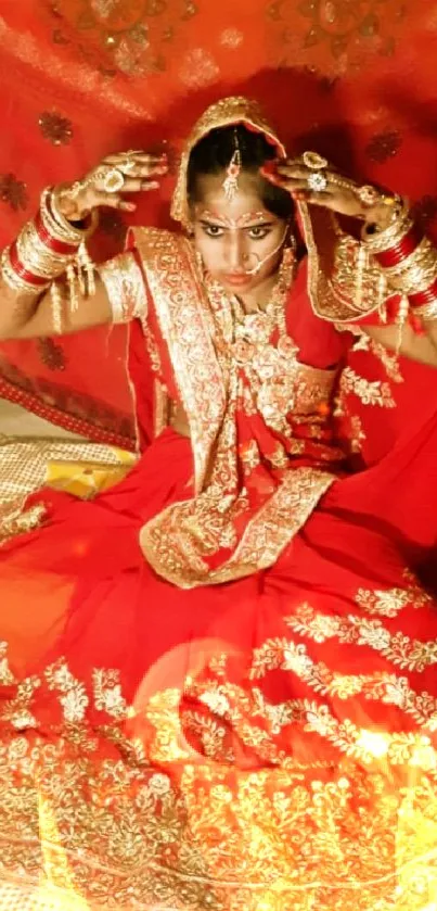 Traditional bride in red attire seated elegantly, showcasing cultural beauty.