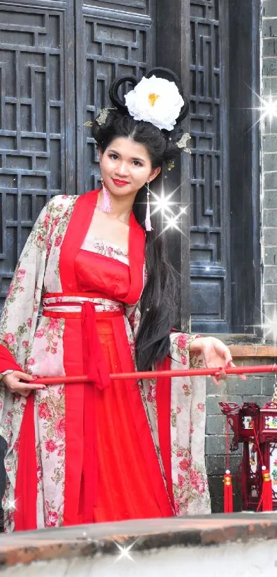 Woman in traditional red dress by a wooden door.