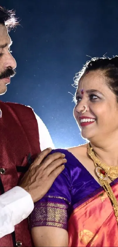 Elegant traditional couple in vibrant cultural attire with jewelry.