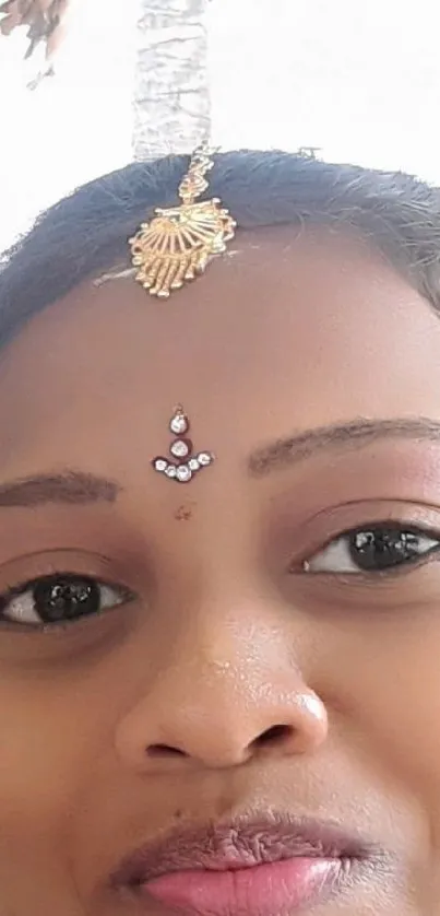 Elegant woman with traditional headpiece and jewelry.