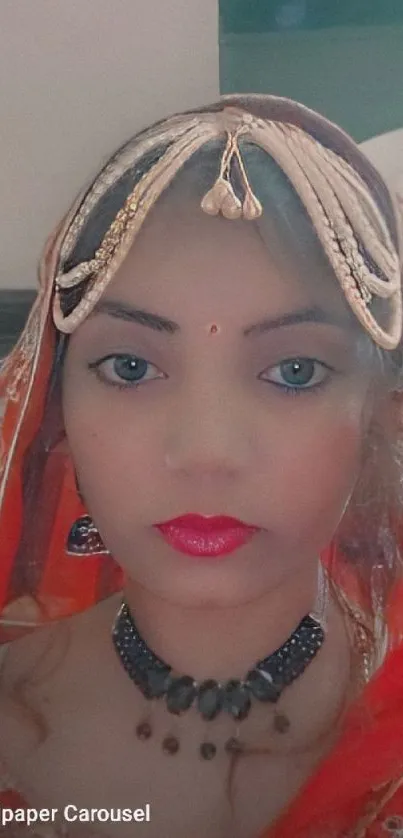 Traditional portrait with red attire and intricate jewelry.